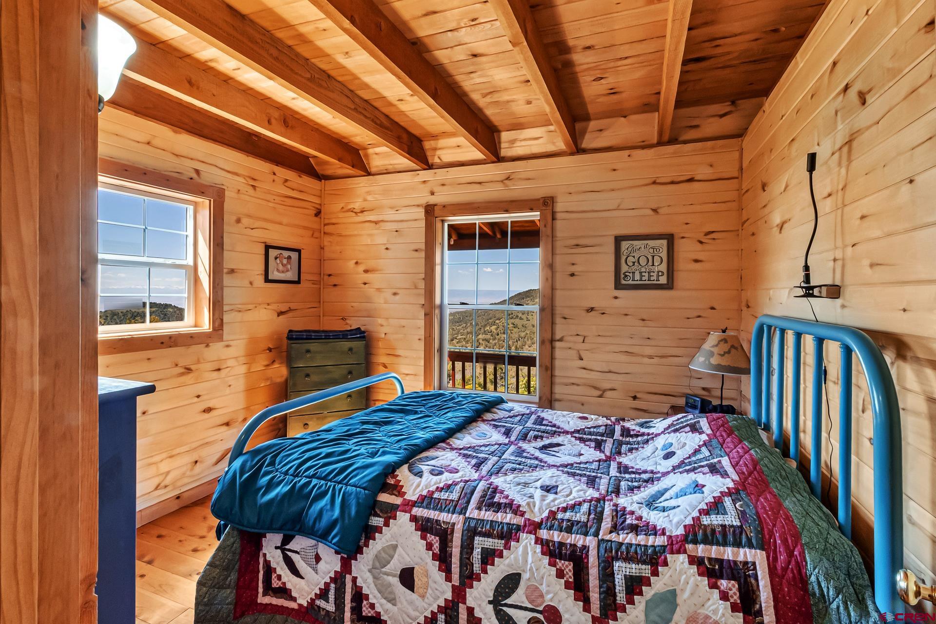 Lot 7 Aspen Hills Road Cedaredge, CO 81413 - Photo 24 of 42 a bedroom with a bed next to a window
