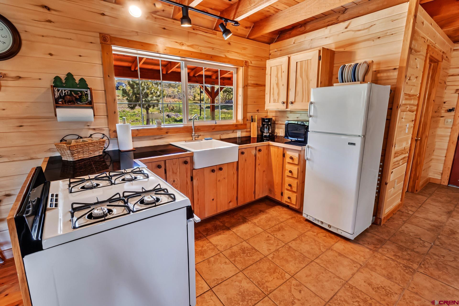 Lot 7 Aspen Hills Road Cedaredge, CO 81413 - Photo 5 of 42 a kitchen with stainless steel appliances granite countertop a stove a refrigerator and a cabinets