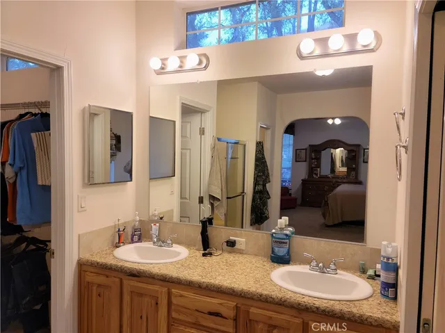 a bathroom with a double vanity sink and a mirror