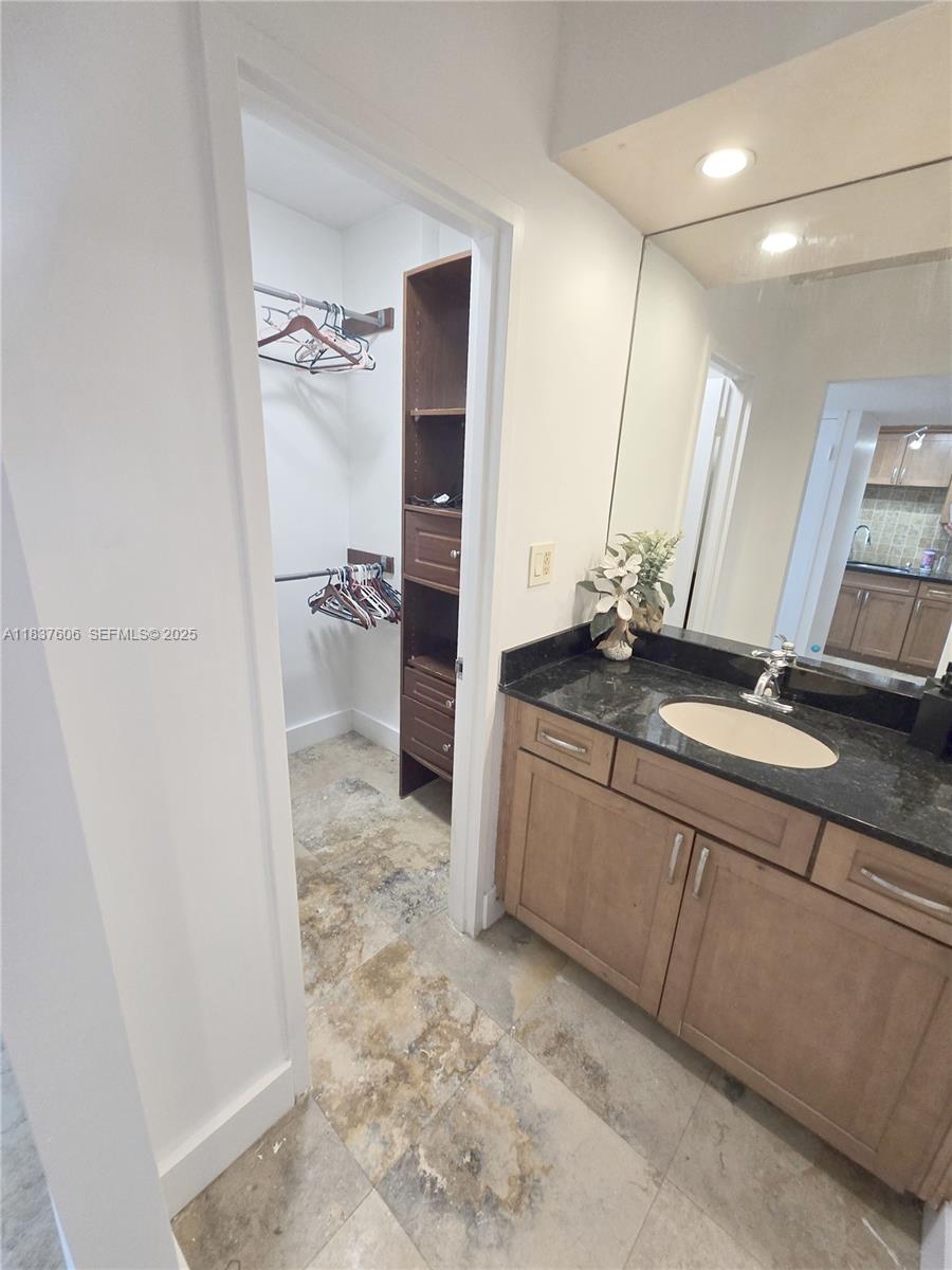 100 Lincoln Road, Unit 1206 Miami Beach, FL 33139 - Photo 14 of 18 a bathroom with a granite countertop sink a toilet and a shower