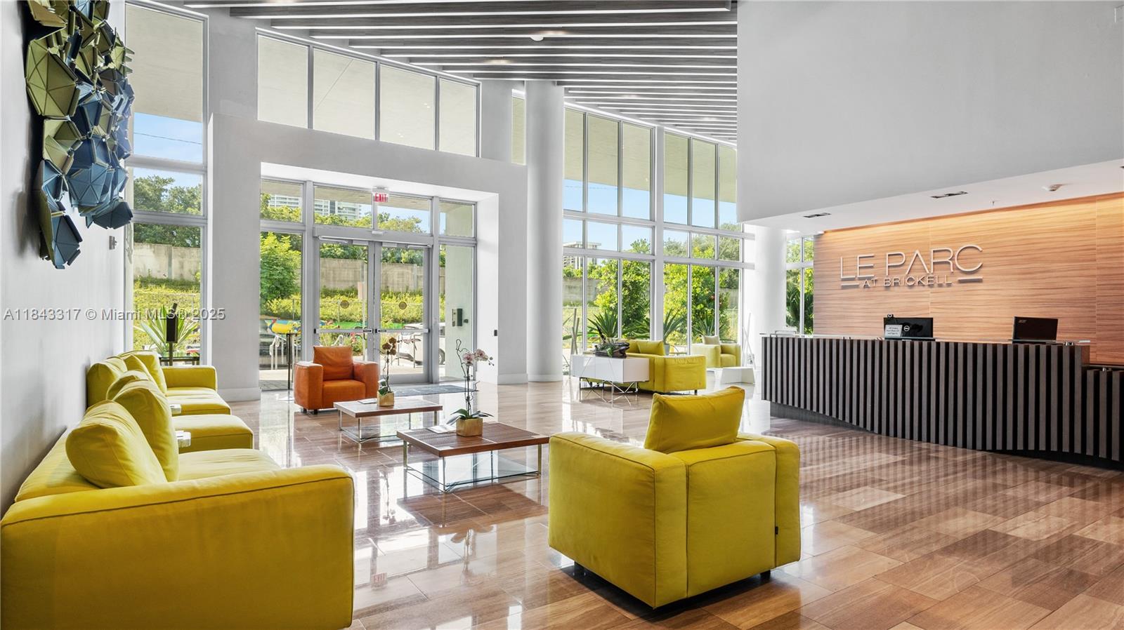 a living room with furniture and a floor to ceiling window