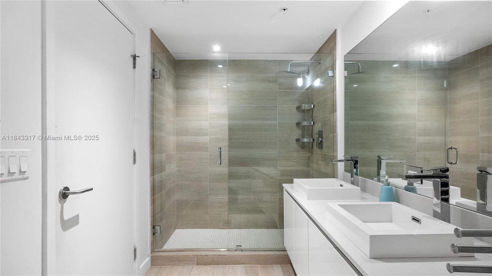 1600 Southwest 1st Avenue, Unit 1104 Miami, FL 33129 - Photo 11 of 22 a bathroom with a sink shower and a mirror