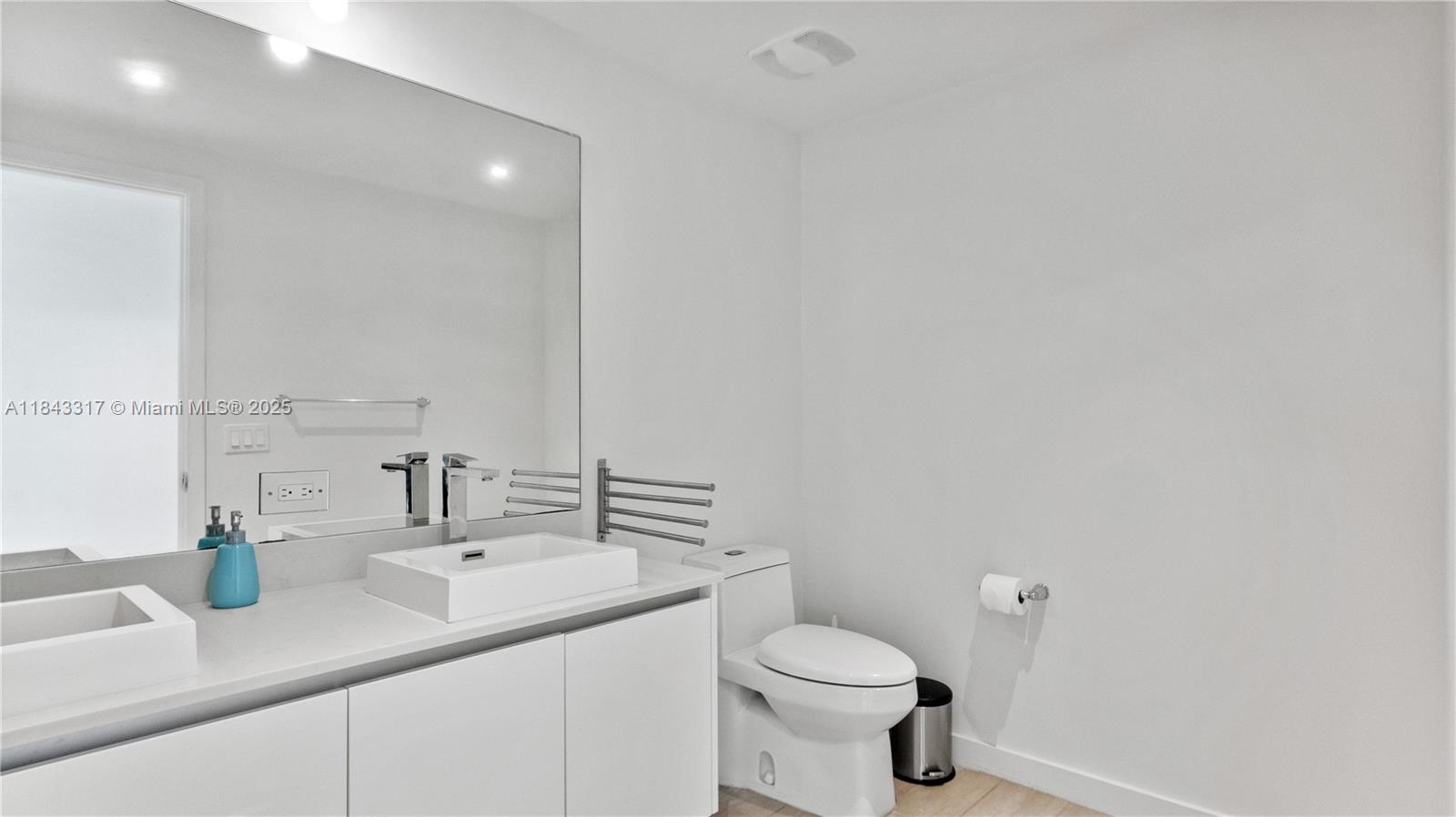 1600 Southwest 1st Avenue, Unit 1104 Miami, FL 33129 - Photo 12 of 22 a bathroom with a sink a toilet and a mirror