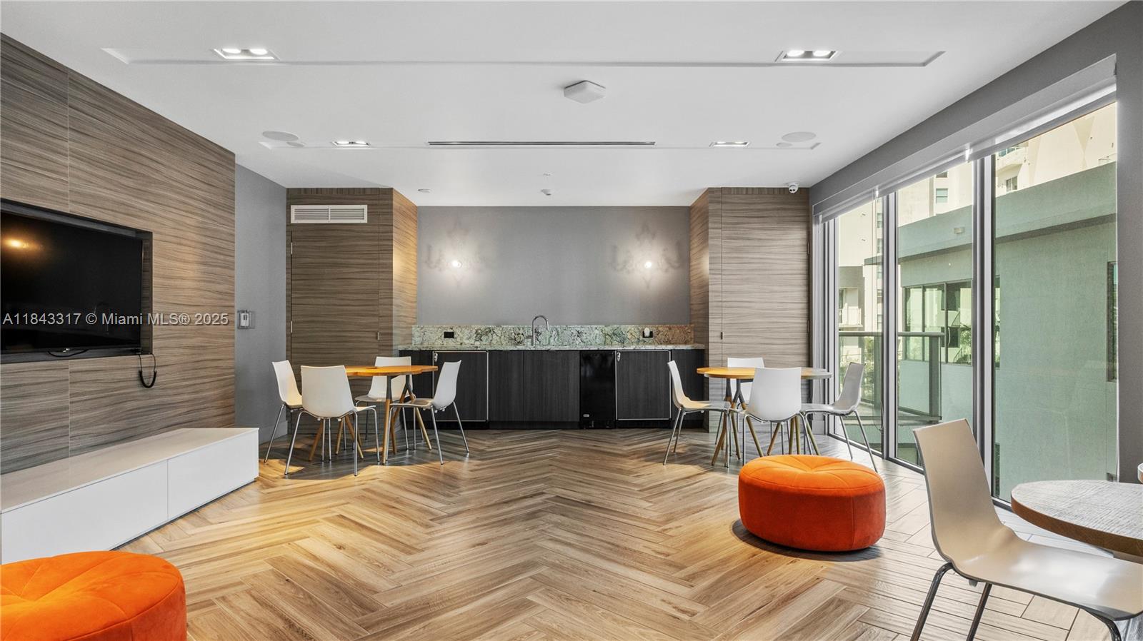 1600 Southwest 1st Avenue, Unit 1104 Miami, FL 33129 - Photo 20 of 22 a living room with furniture a flat screen tv and a large window