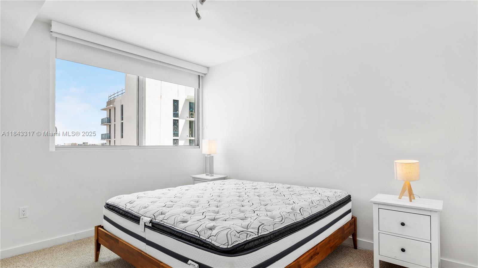 1600 Southwest 1st Avenue, Unit 1104 Miami, FL 33129 - Photo 9 of 22 a bedroom with a bed and a window