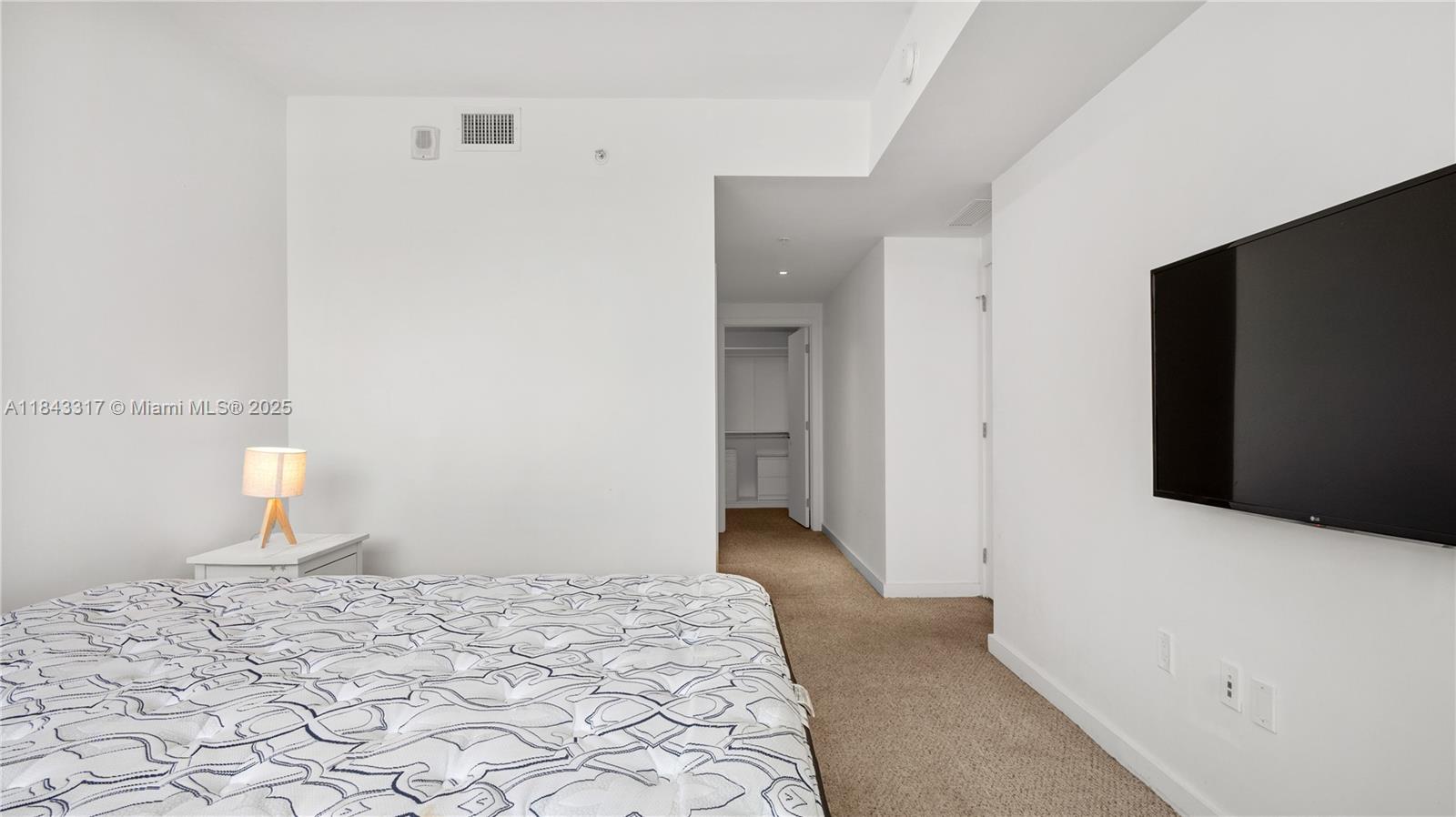 1600 Southwest 1st Avenue, Unit 1104 Miami, FL 33129 - Photo 10 of 22 a bedroom with a bed and a mirror