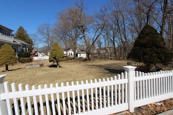 a view of street with wooden fence