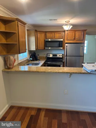 a kitchen with kitchen island a sink counter top space and stainless steel appliances