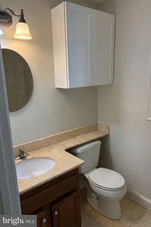 a picture of a bathroom with a shower and a view of a wall