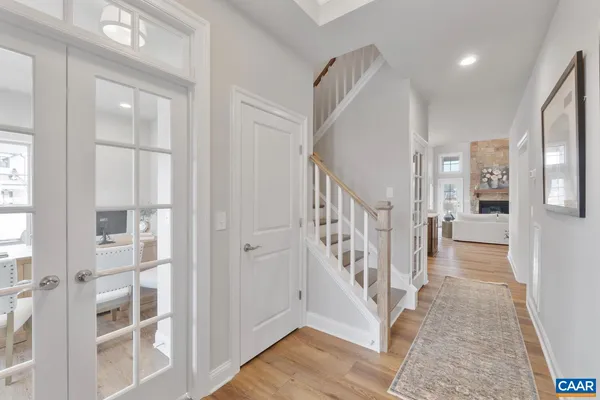 a kitchen with stainless steel appliances granite countertop a sink a stove and a wooden floors