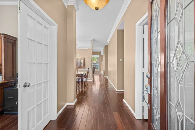 a view of a hallway with wooden floor and staircase