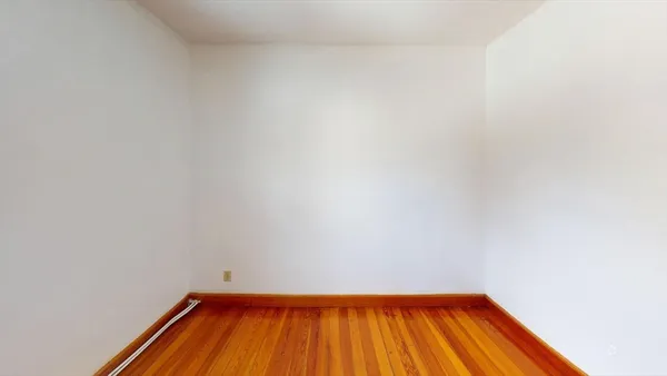 a view of a small space with wooden floor