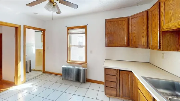 a view of a kitchen with wooden floor and furniture