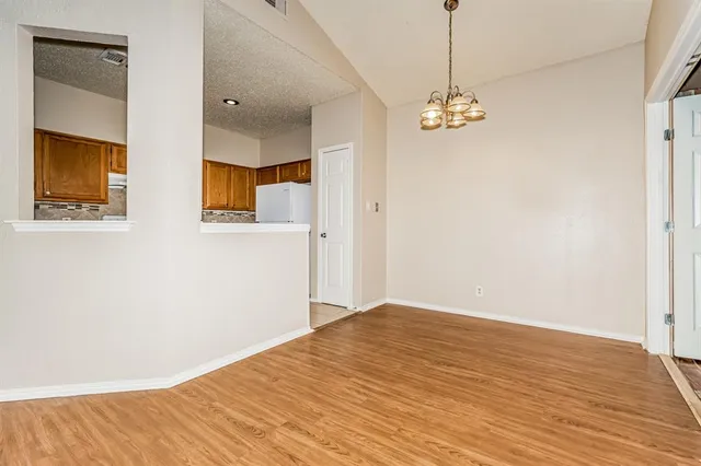 a view of a room with wooden floor and windows