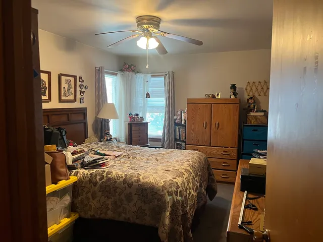 a bedroom with a bed and a chandelier