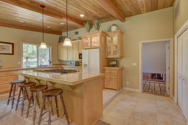 a kitchen with appliances cabinets and furniture