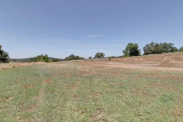 an aerial view of a house with yard and outdoor seating