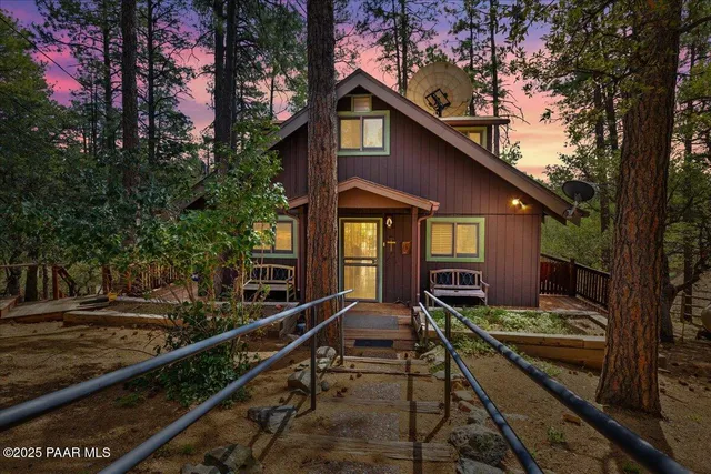 a view of a house with pool and sitting area