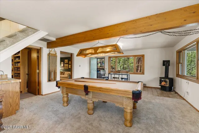 a living room with furniture a table and large windows