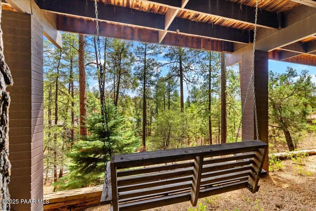 a backyard of a house with lots of green space and wooden fence