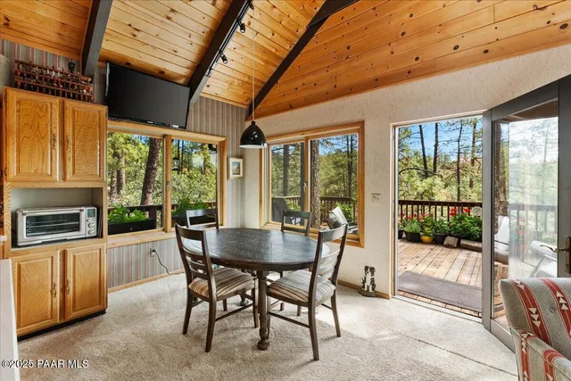 a dining room with furniture a fireplace and wooden floor