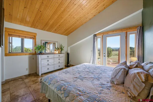 a spacious bedroom with a bed and a view of bathroom