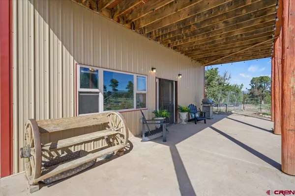a spacious bedroom with a large window and a balcony