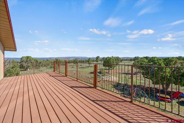 a view of a balcony with wooden floor and city view