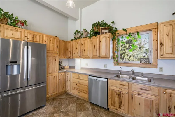 a kitchen with a sink stainless steel appliances and cabinets