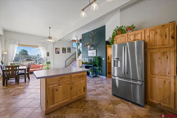 a kitchen with stainless steel appliances a refrigerator and a refrigerator