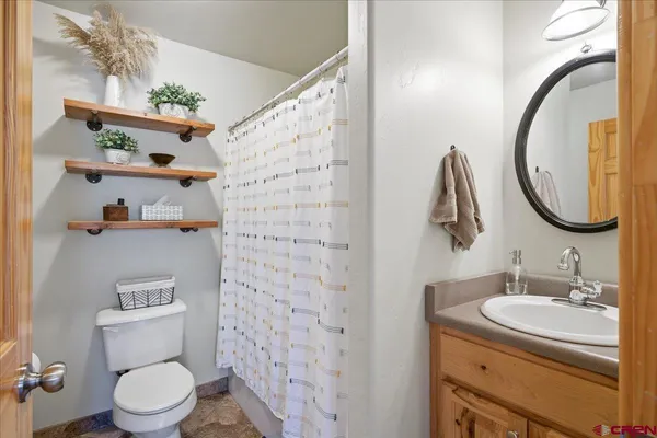 a bathroom with a sink toilet and a mirror