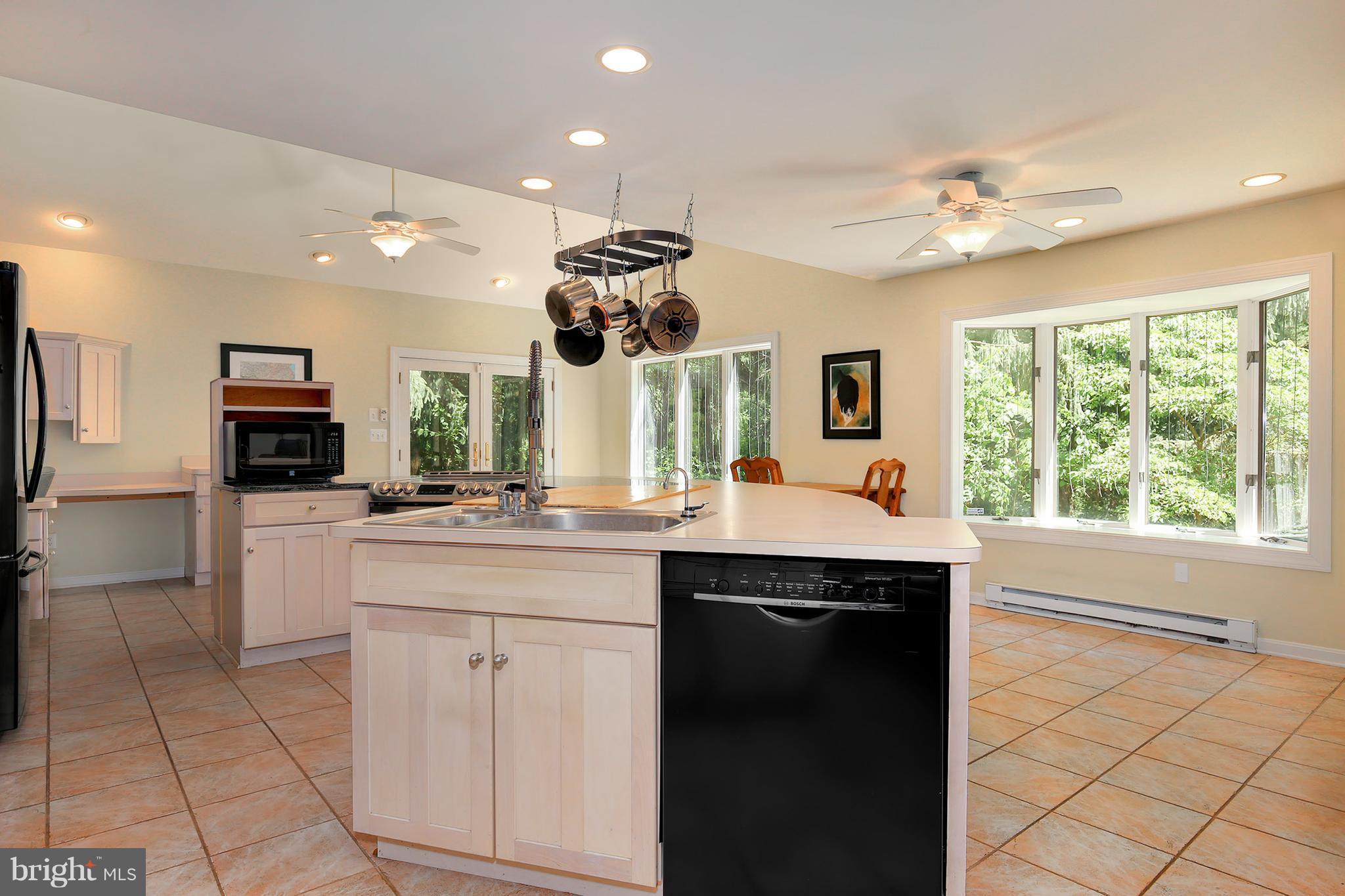 9116 Gue Road Damascus, MD 20872 - Photo 14 of 30 a kitchen with kitchen island granite countertop a sink and appliances
