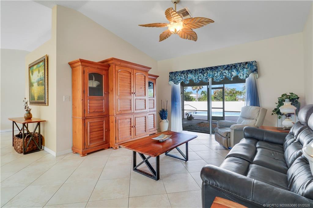 5439 Southeast Horseshoe Point Road Stuart, FL 34997 - Photo 17 of 53 a living room with furniture a chandelier and a window