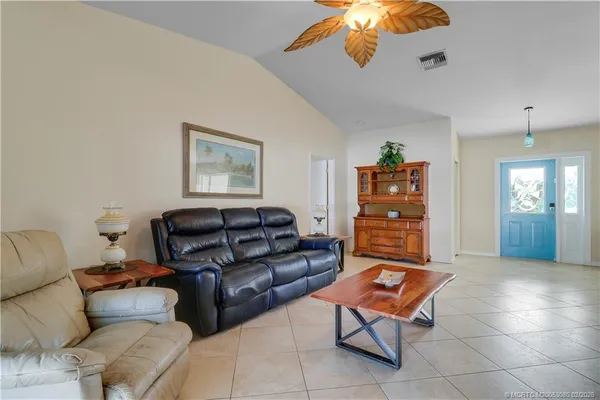 a dining room with furniture a chandelier and wooden floor