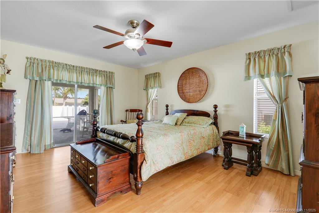 5439 Southeast Horseshoe Point Road Stuart, FL 34997 - Photo 20 of 52 a bed room with a bed and a chandelier