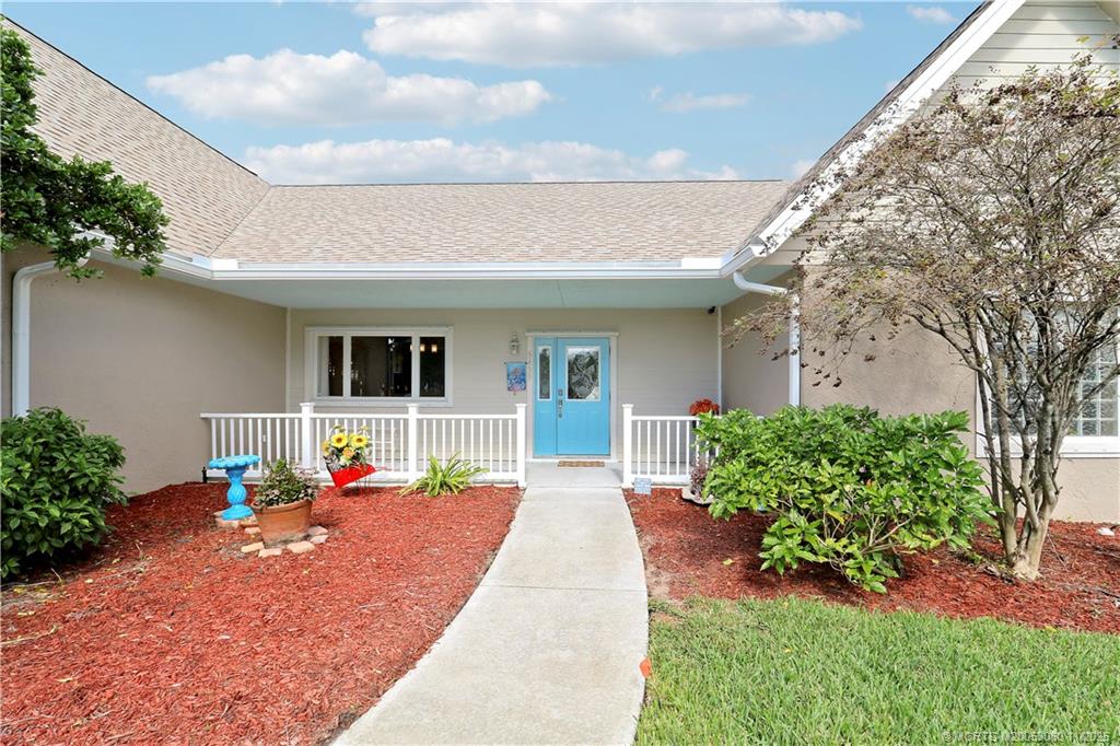 5439 Southeast Horseshoe Point Road Stuart, FL 34997 - Photo 2 of 52 a front view of a house with a porch