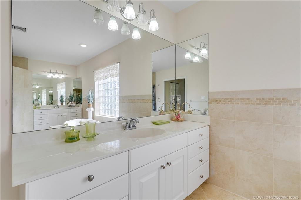 5439 Southeast Horseshoe Point Road Stuart, FL 34997 - Photo 27 of 53 a bathroom with 2 sink and a mirror