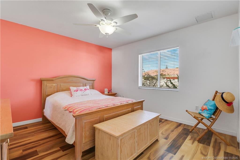 5439 Southeast Horseshoe Point Road Stuart, FL 34997 - Photo 27 of 52 a bedroom with a bed and a chandelier