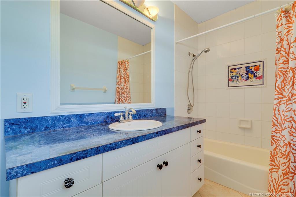 5439 Southeast Horseshoe Point Road Stuart, FL 34997 - Photo 31 of 53 a bathroom with a granite countertop sink mirror vanity and bathtub