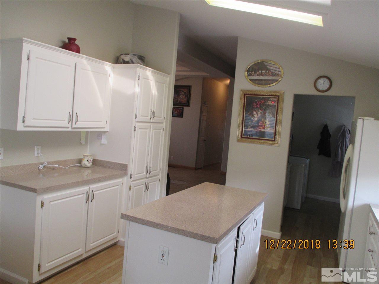 1306 Lynx Street Reno, NV 89506 - Photo 8 of 22 a kitchen with a sink a refrigerator and cabinets
