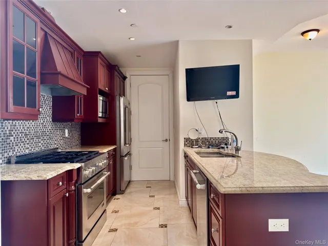 a kitchen with stainless steel appliances granite countertop a stove and a sink