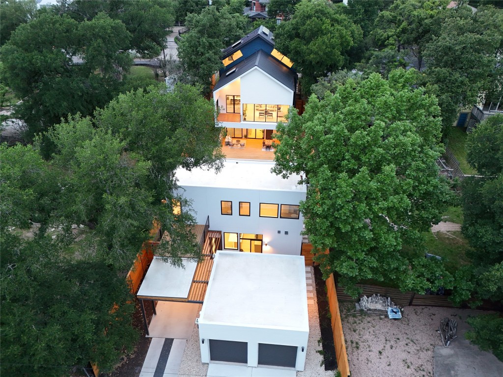 aerial view of house with trees in the background