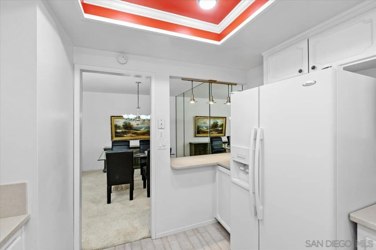12491 Rios Road Rancho Bernardo, CA 92128 - Photo 13 of 21 a kitchen with white cabinets and stainless steel appliances
