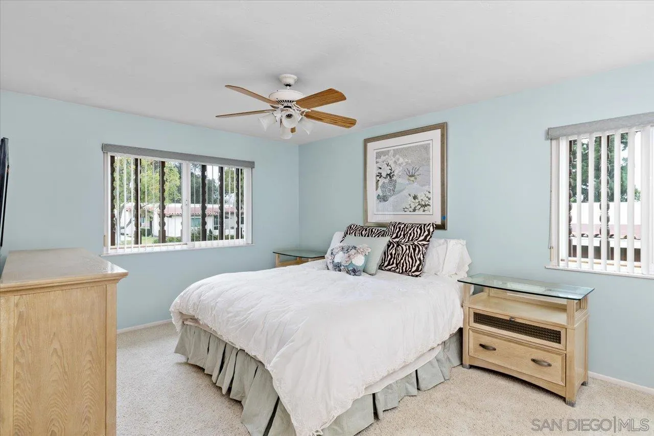 12491 Rios Road Rancho Bernardo, CA 92128 - Photo 15 of 21 a bedroom with a bed dresser and a window