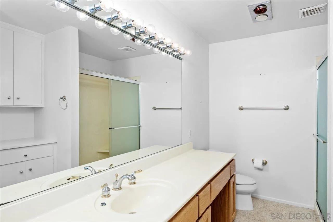 12491 Rios Road Rancho Bernardo, CA 92128 - Photo 18 of 21 a bathroom with a sink a toilet and shower