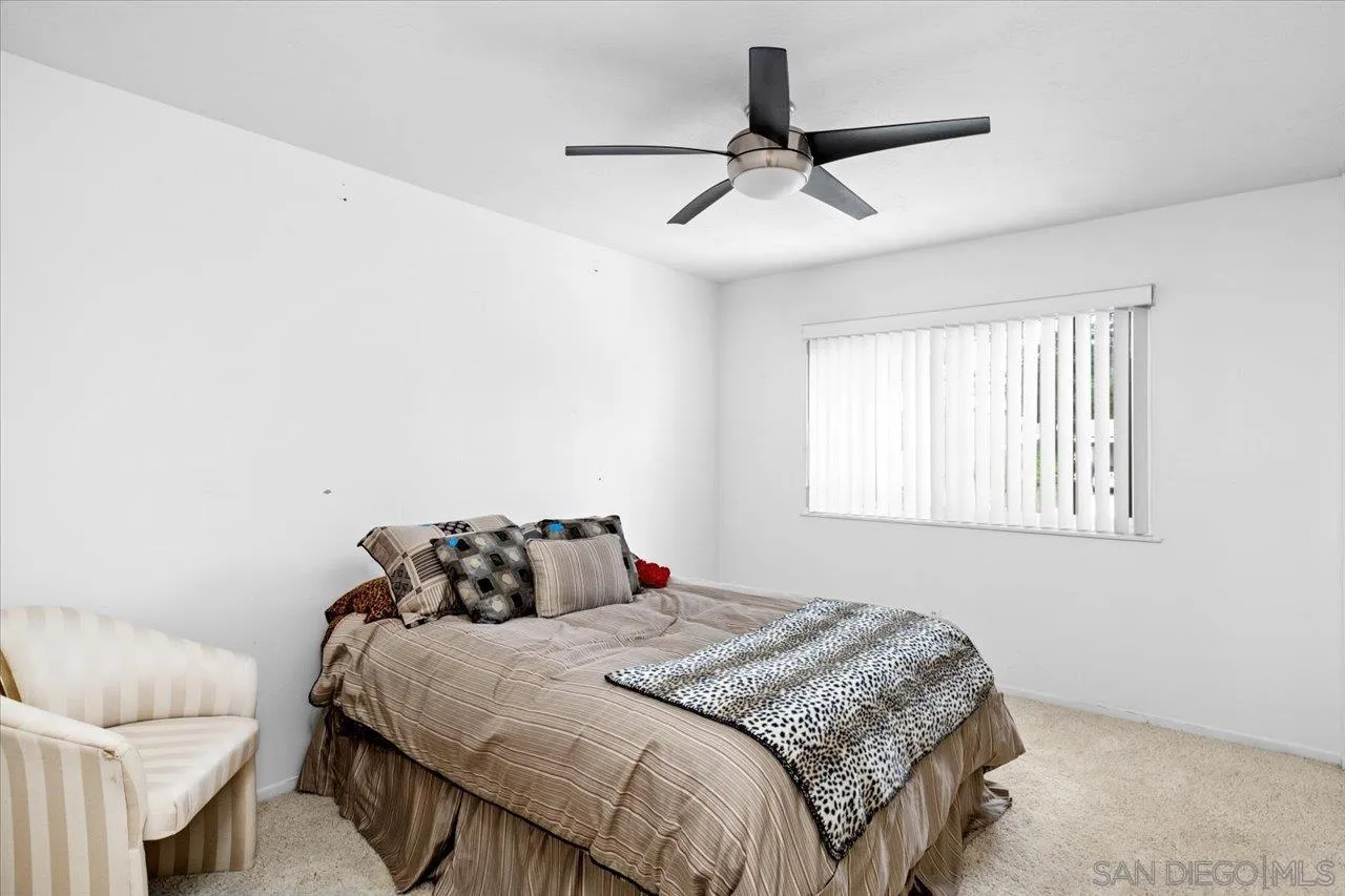 12491 Rios Road Rancho Bernardo, CA 92128 - Photo 18 of 21 a bedroom with a bed and window