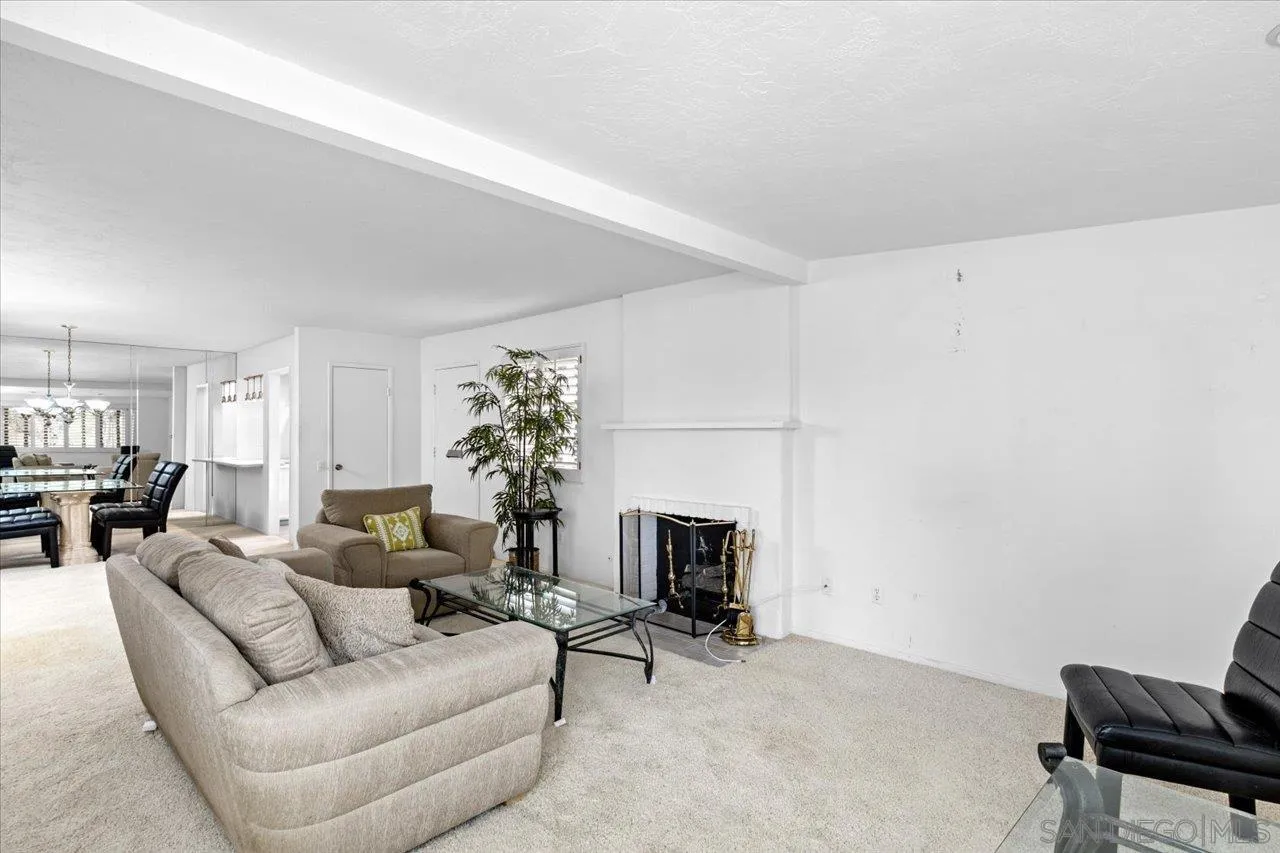 12491 Rios Road Rancho Bernardo, CA 92128 - Photo 7 of 21 a living room with furniture a fireplace and a potted plant
