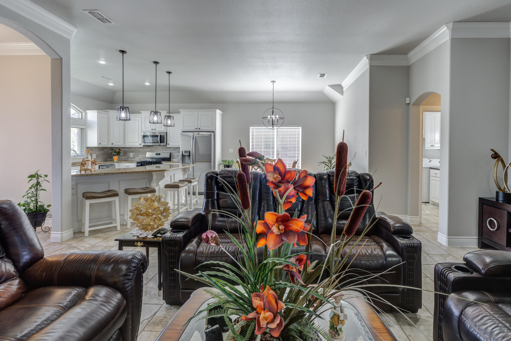 6306 87th Street Lubbock, TX 79424 - Photo 13 of 47 a living room filled with furniture and a dining table with kitchen view