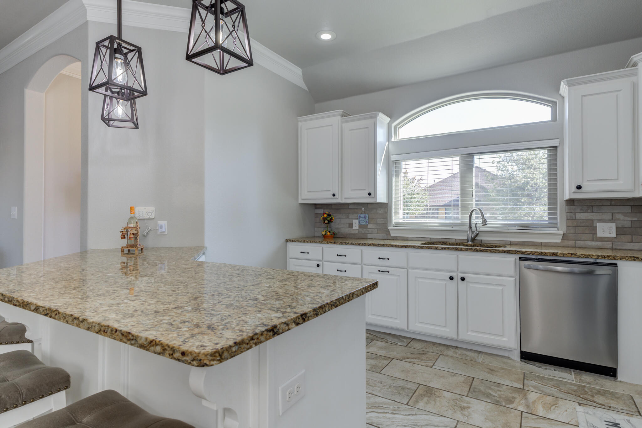 6306 87th Street Lubbock, TX 79424 - Photo 18 of 47 a kitchen with a sink granite counter tops and a window