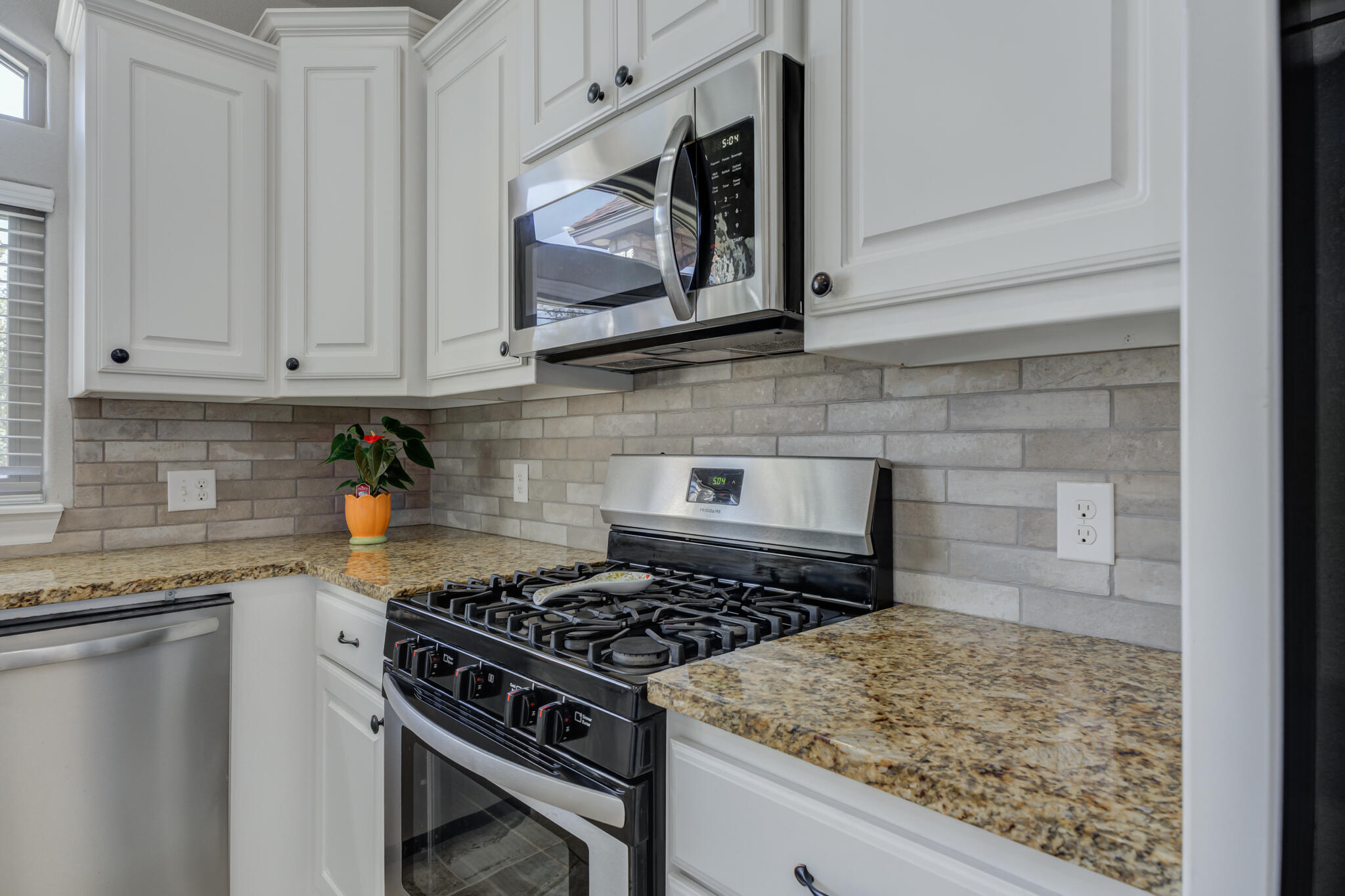 6306 87th Street Lubbock, TX 79424 - Photo 20 of 47 a kitchen with white cabinets and appliances